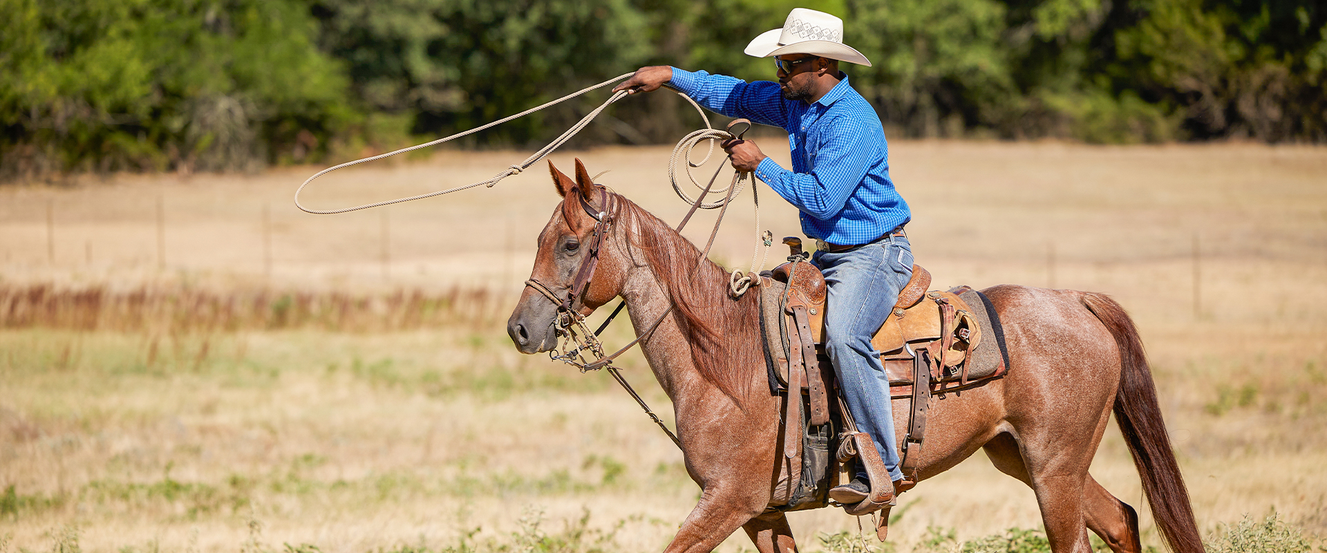 Stephan on horse back with lasso